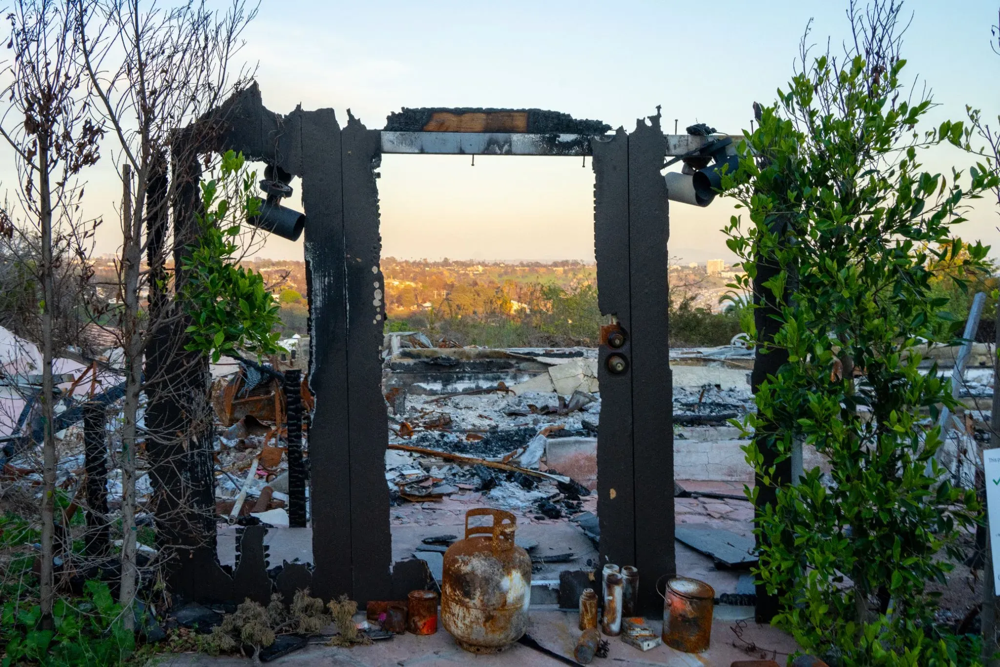 Amid charred ruins of a residential neighborhood, a windowsill stands