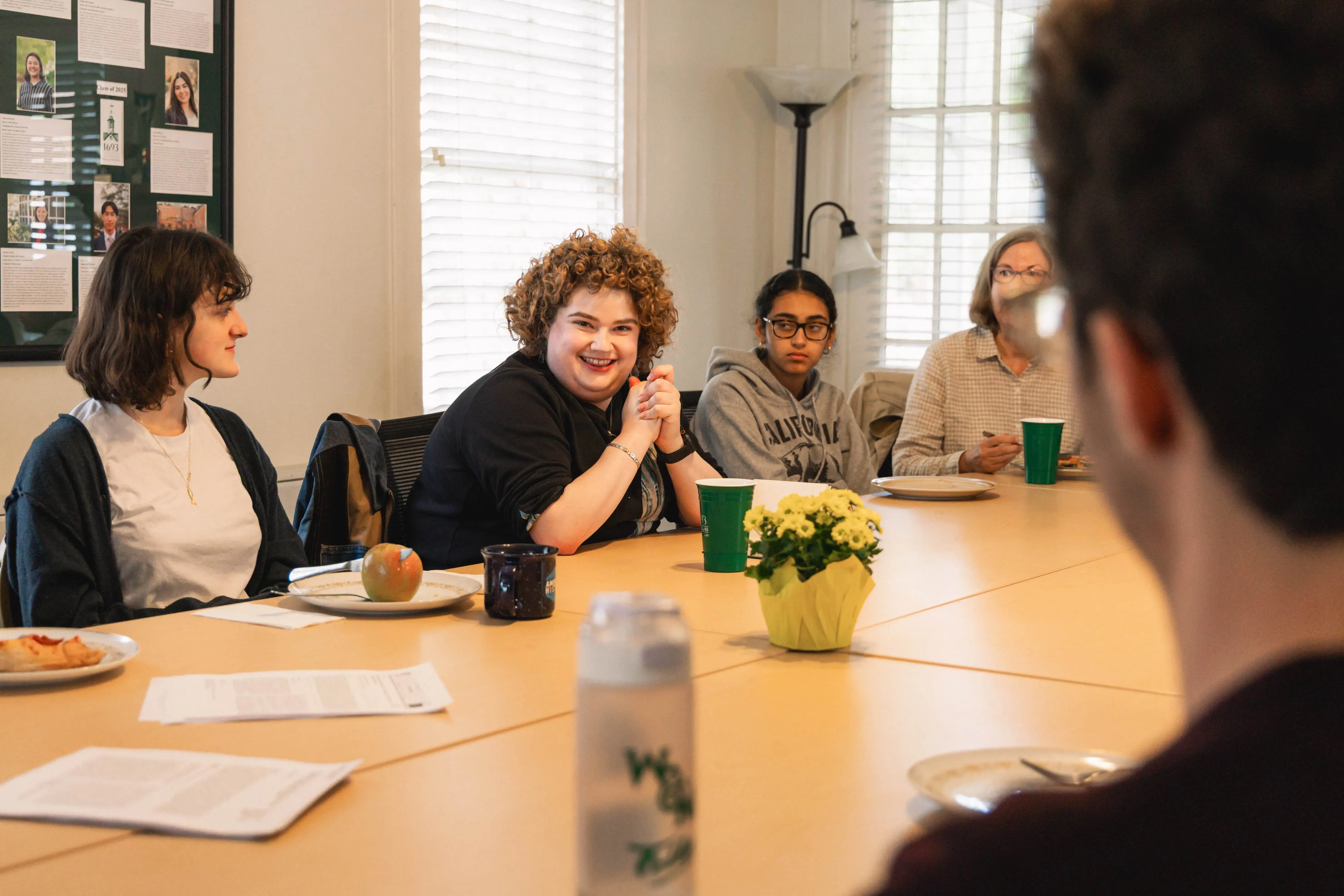 People speak at a conference table