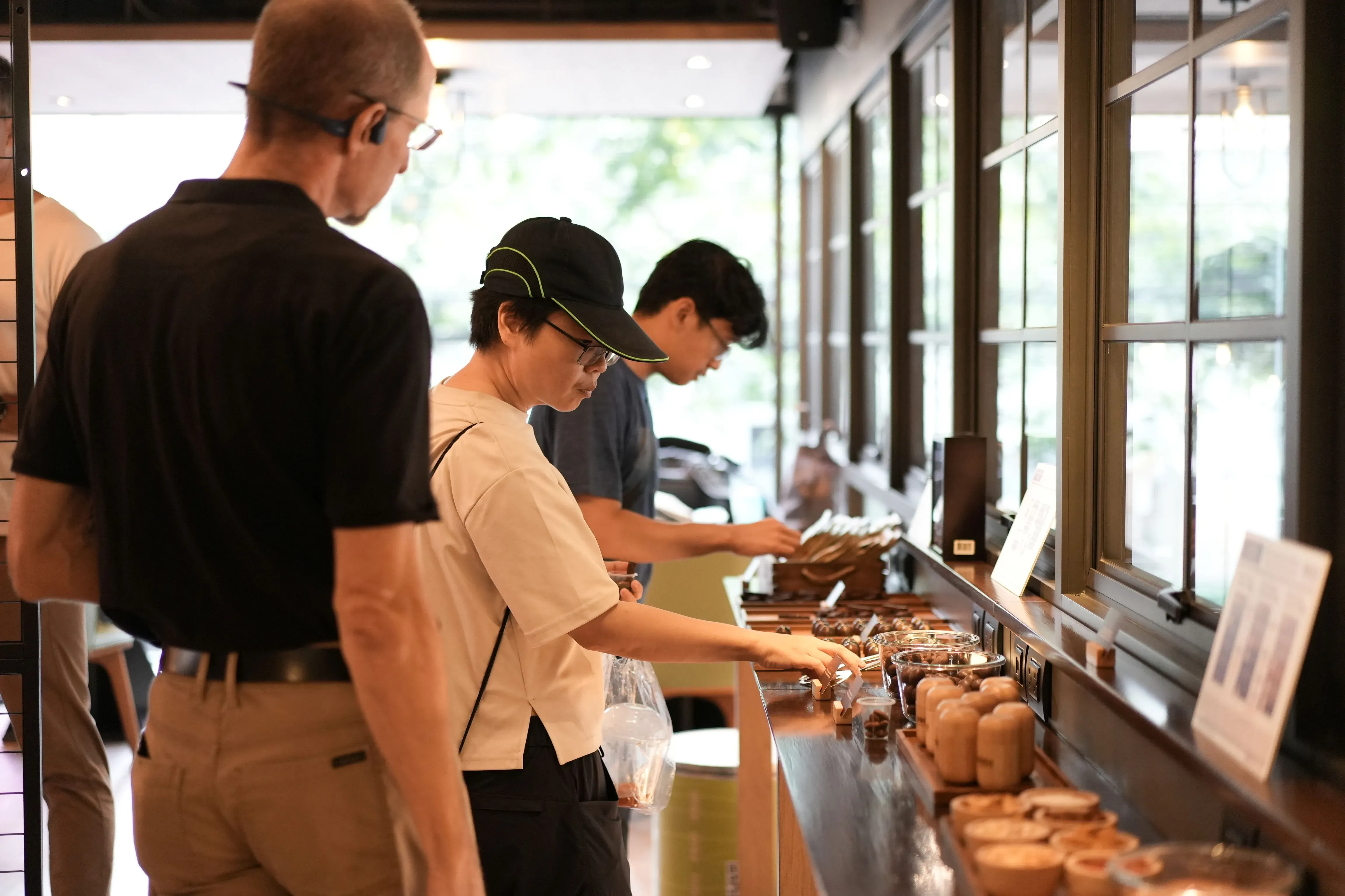 Visitors observe cacao seeds and materials at a cacao exhibit