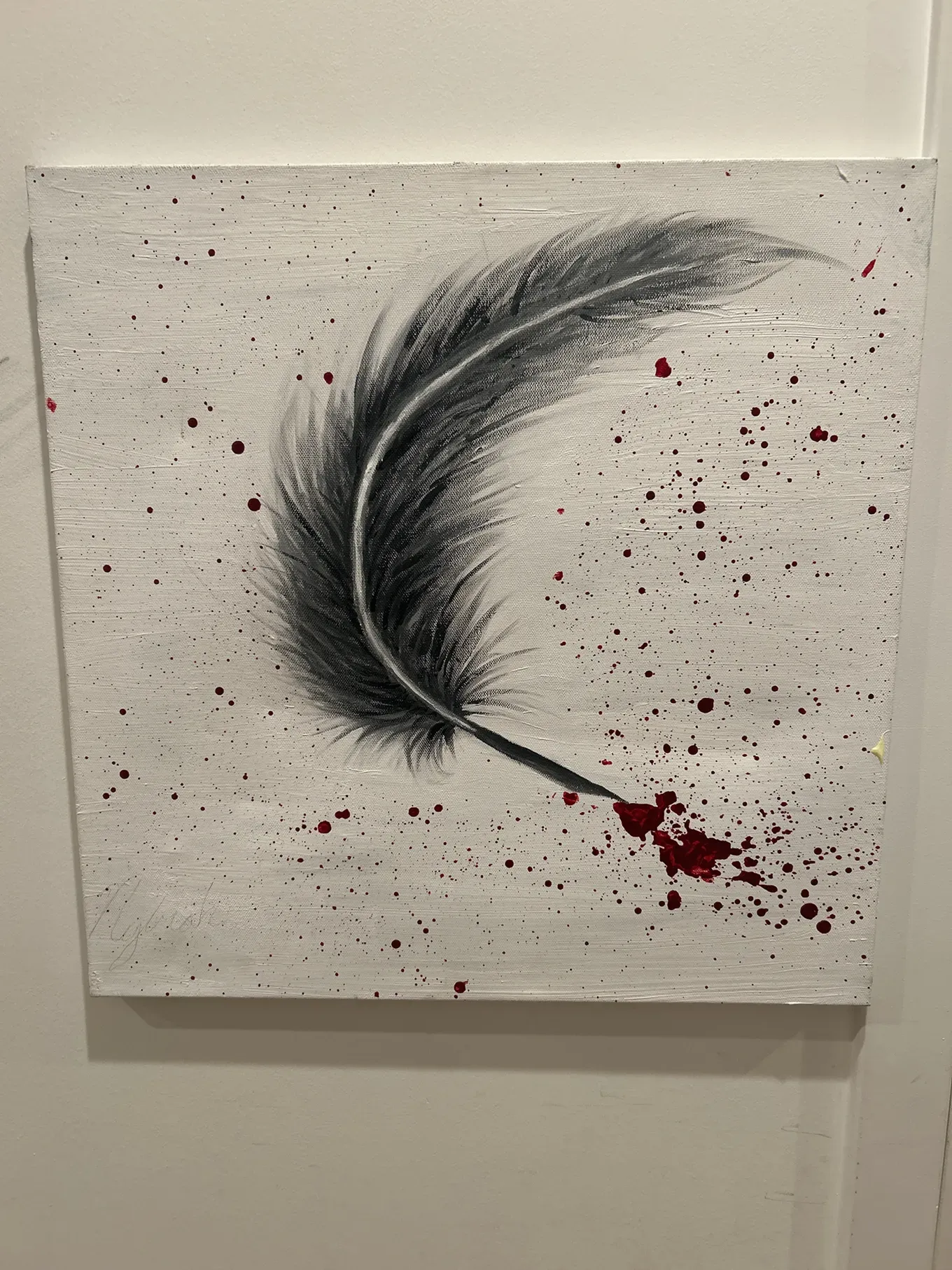 A feather quill splatters blood-red ink on a white canvas