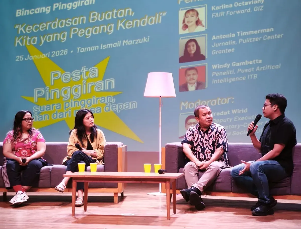 Four people speak on a panel during an event