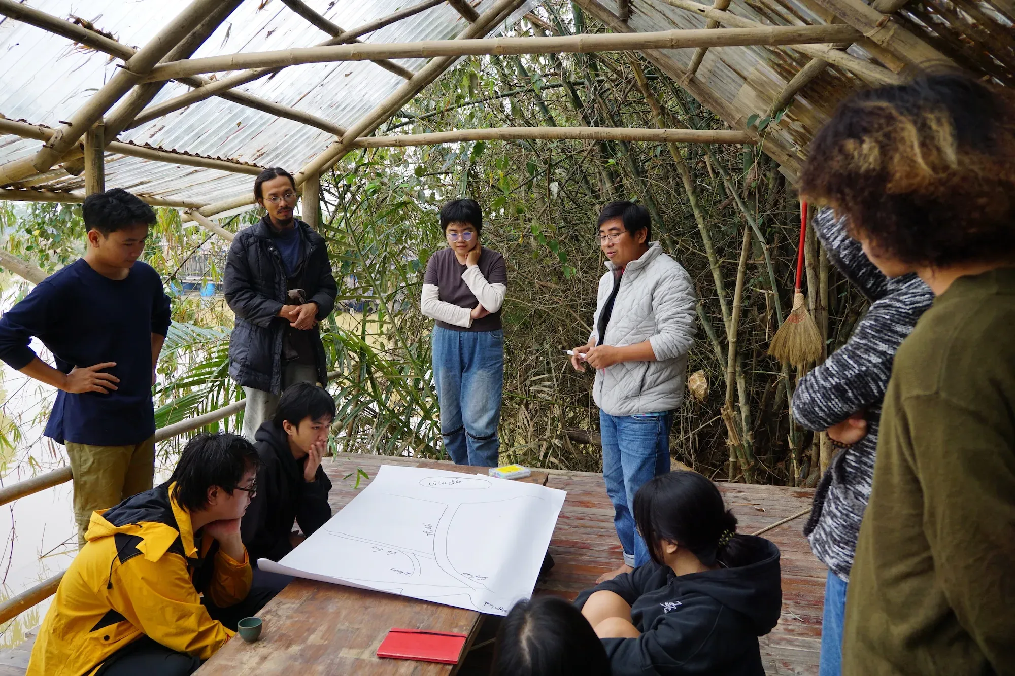 A session led by Phan Công Sanh, an ecology and conservation expert, utilizing flow-diagrams to map the Thu Bồn river system and the biological infrastructure of its mangroves. Image courtesy of the Thì Collective