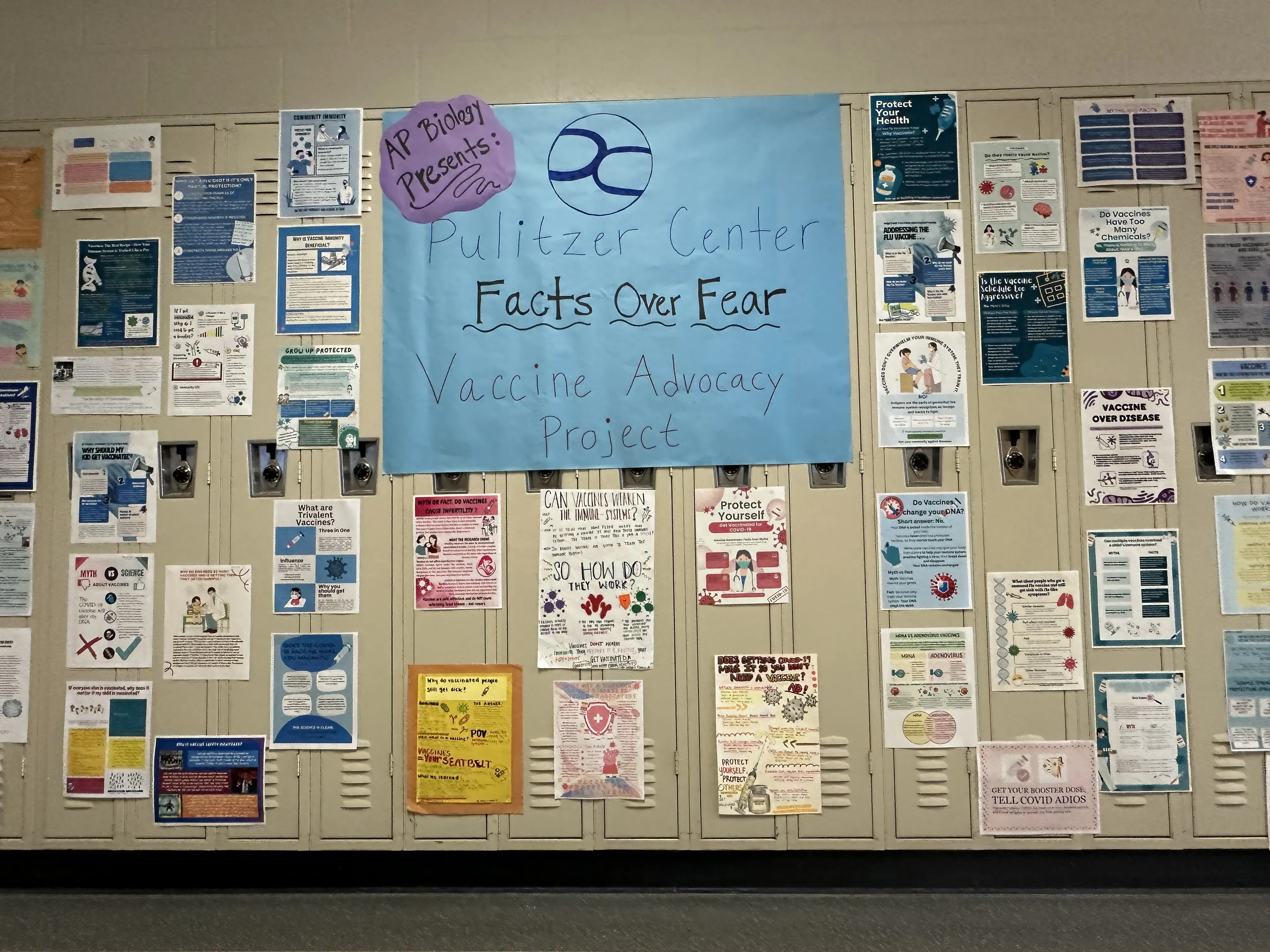A collection of student-created vaccine awareness flyers hangs in a hallway at Troy High School. Image by Rebecca Brewer.