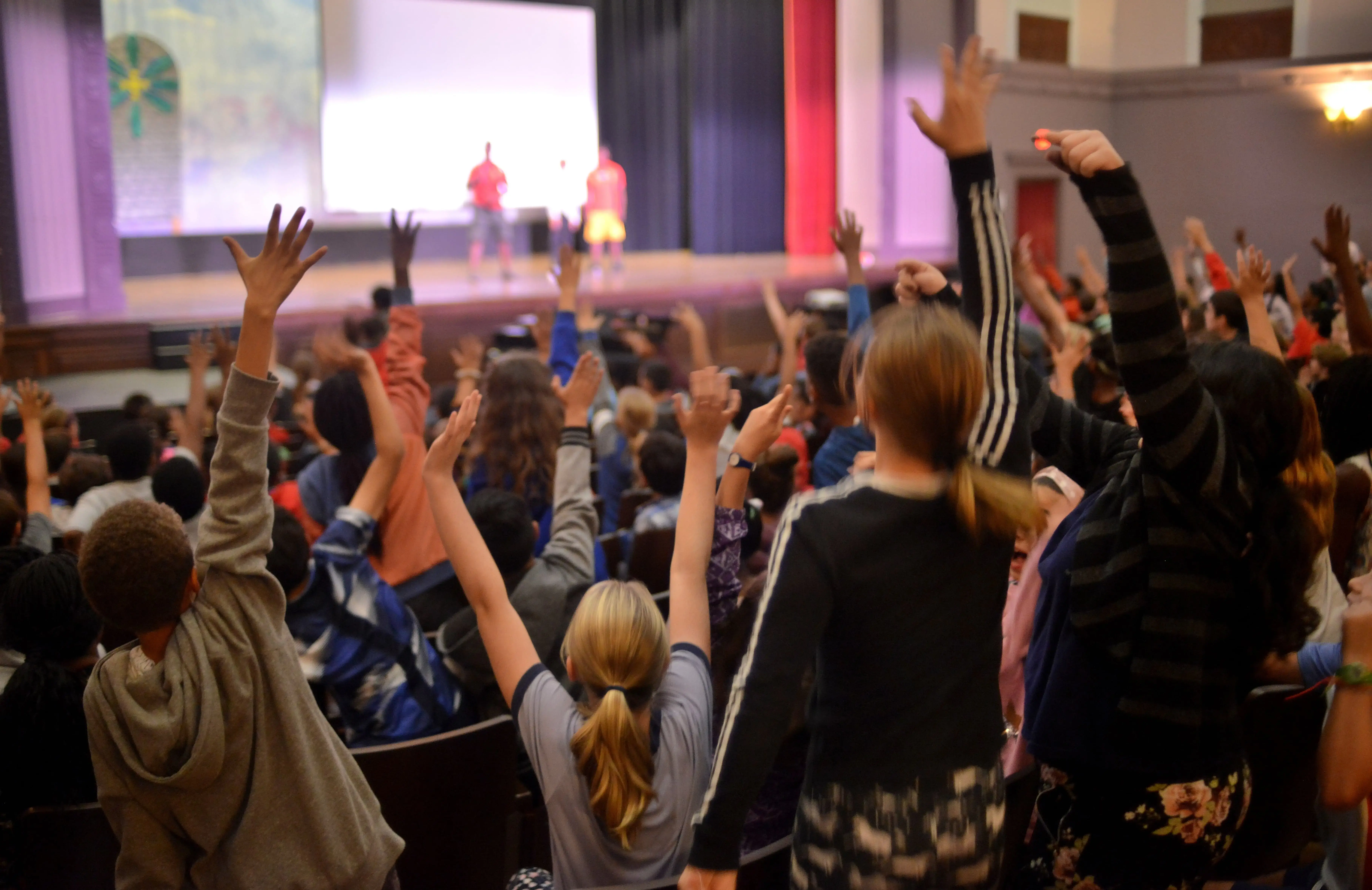 Eager students volunteer to participate in acrobatics onstage. Image by Dermot Tatlow. United States, 2018.