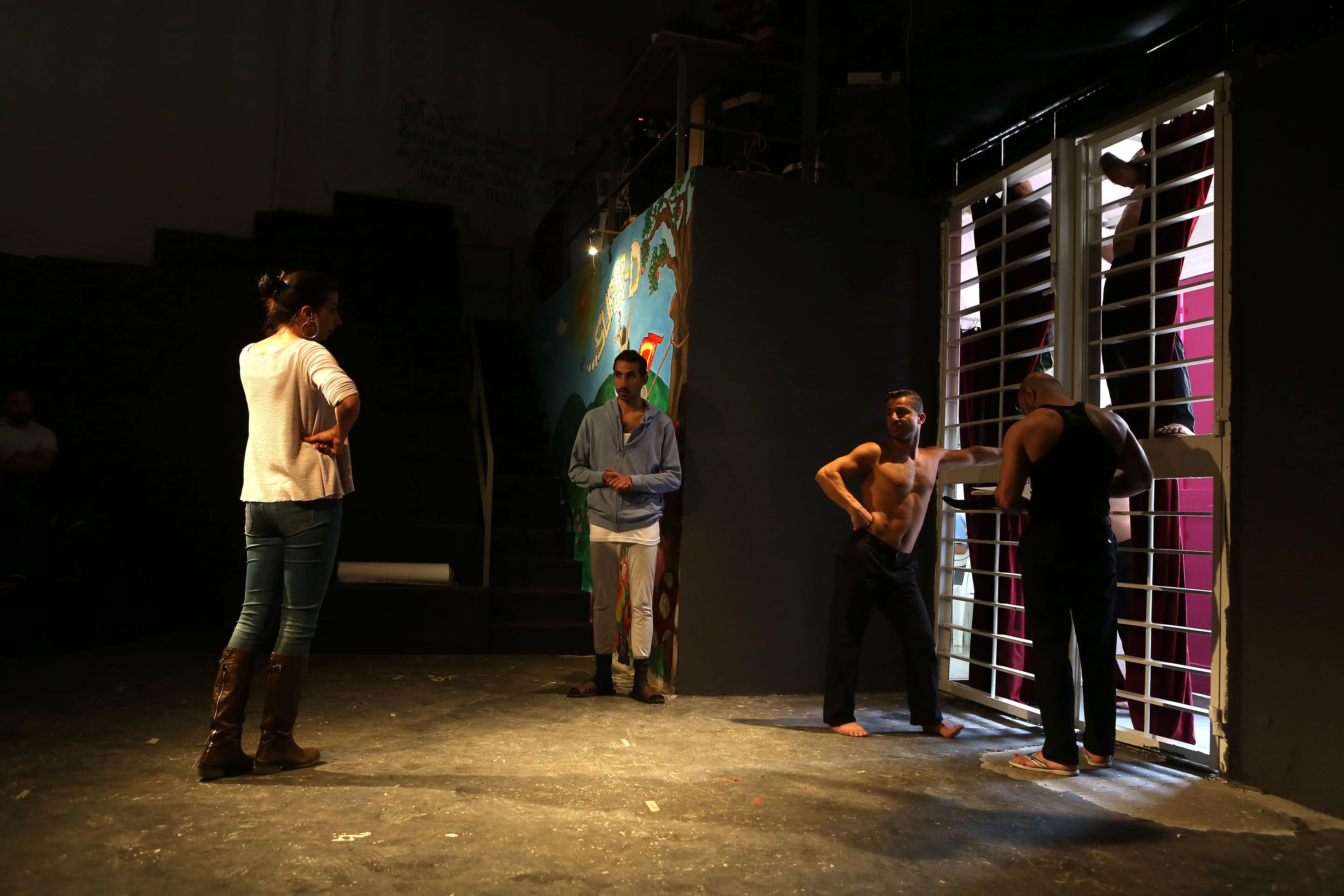 Actors and directors at work setting up a stage.