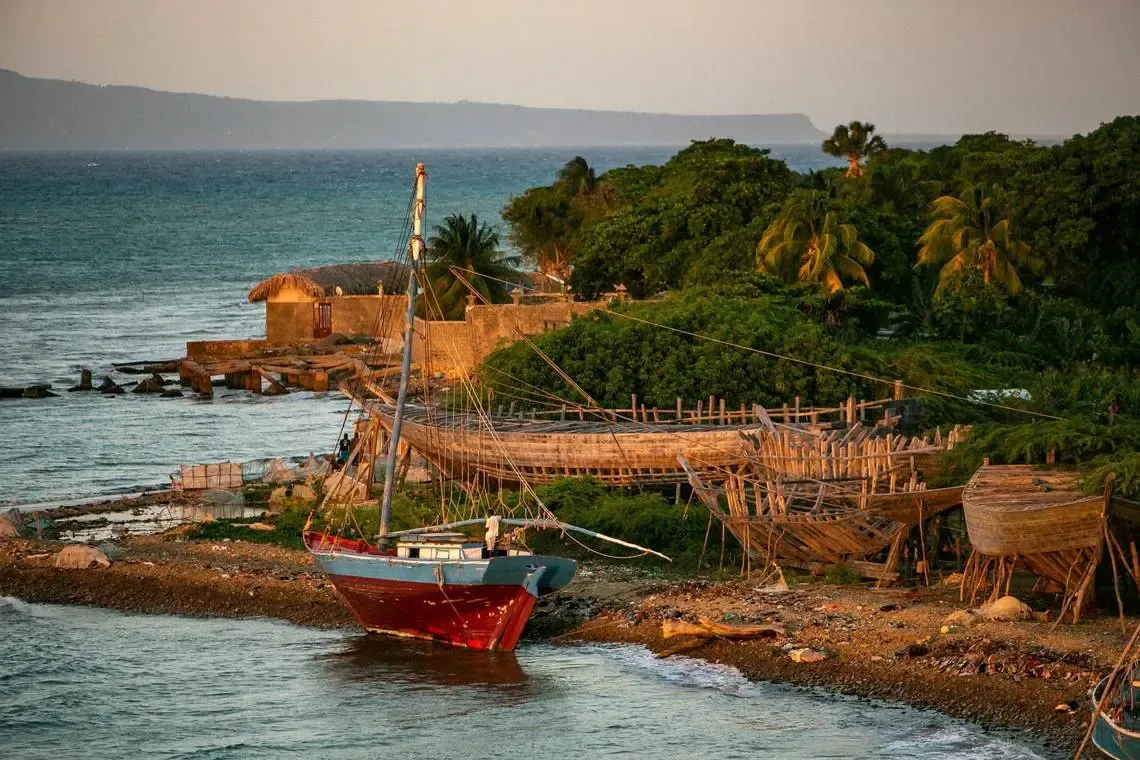 boats and boats under construction sit next to the water 