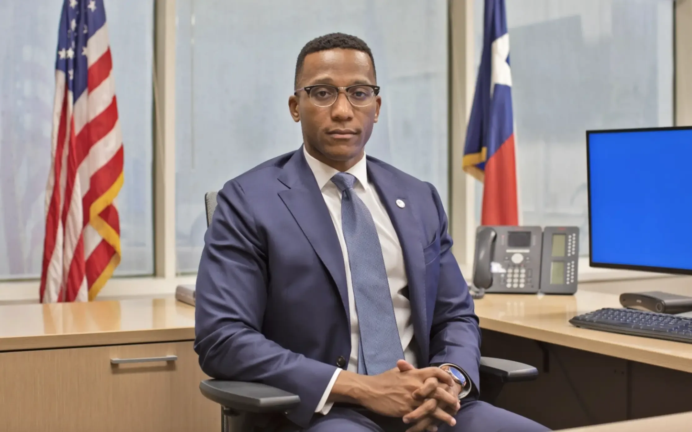 A man sits at his desk 