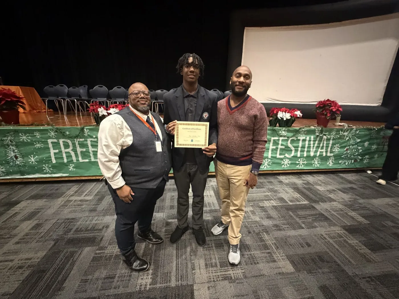 Timothy Moore and his student stand for a picture with Shelby County Mayor, Lee Harris