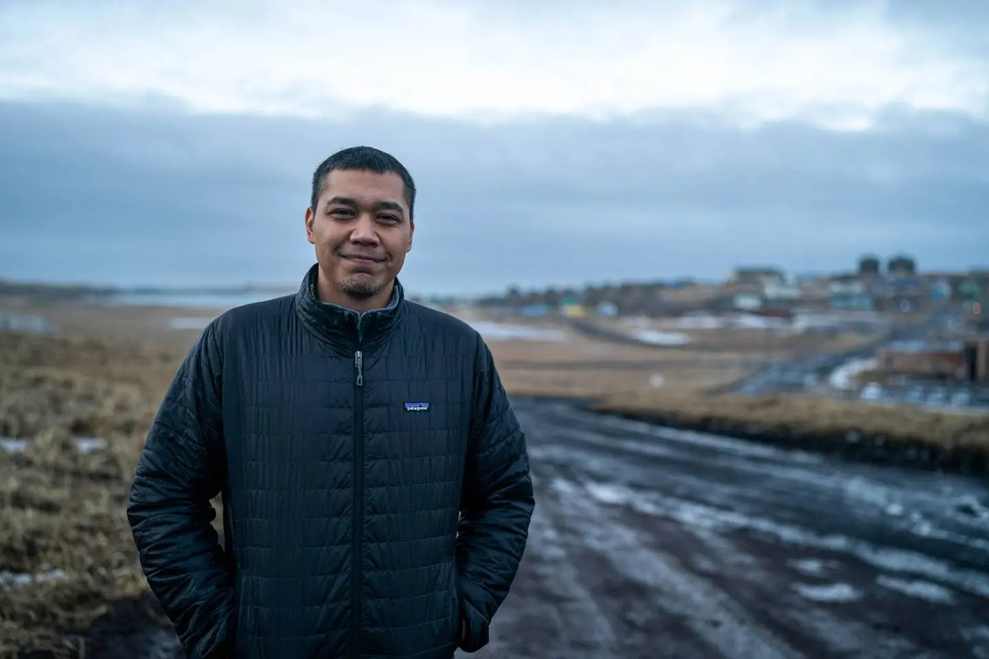 A man poses for a photo in town of St. Paul Alaska 