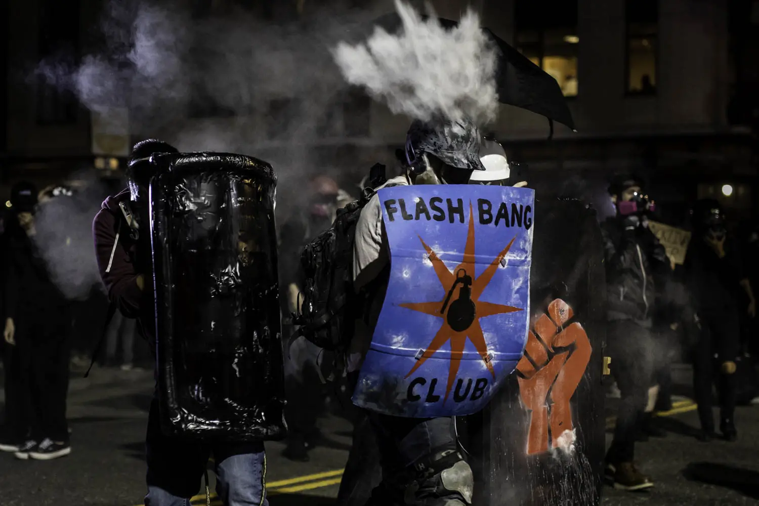 A protester holding a shield is hit in the head with a “less-lethal” projectile during a demonstration on August 19, 2020. 