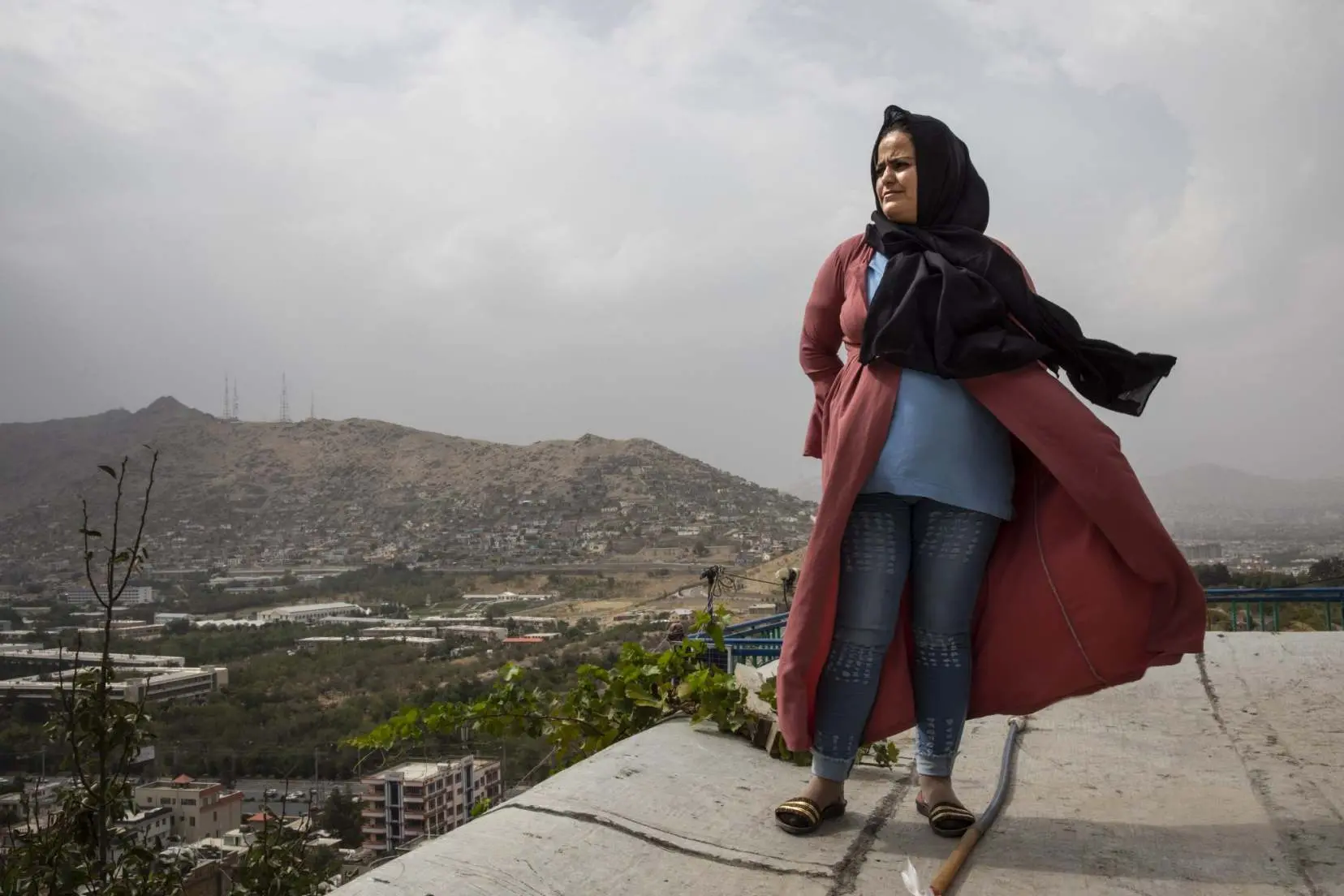 Woman stands on building