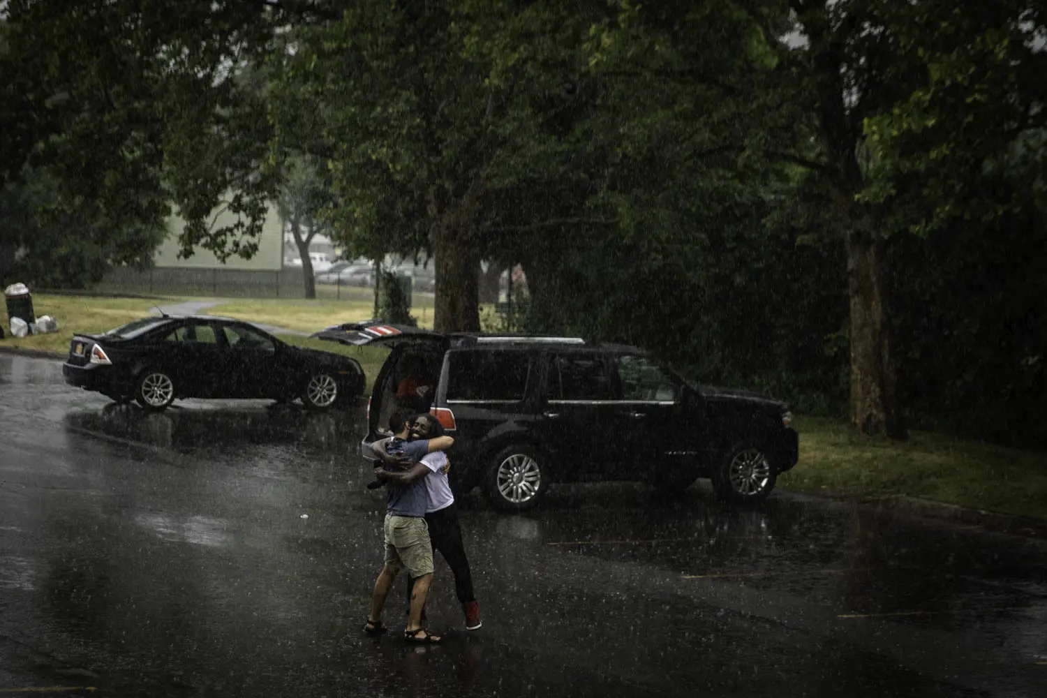 Two people hug in the rain.