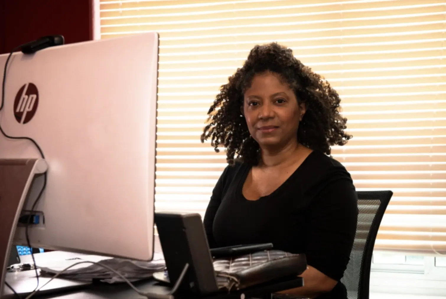 a woman sits at desk