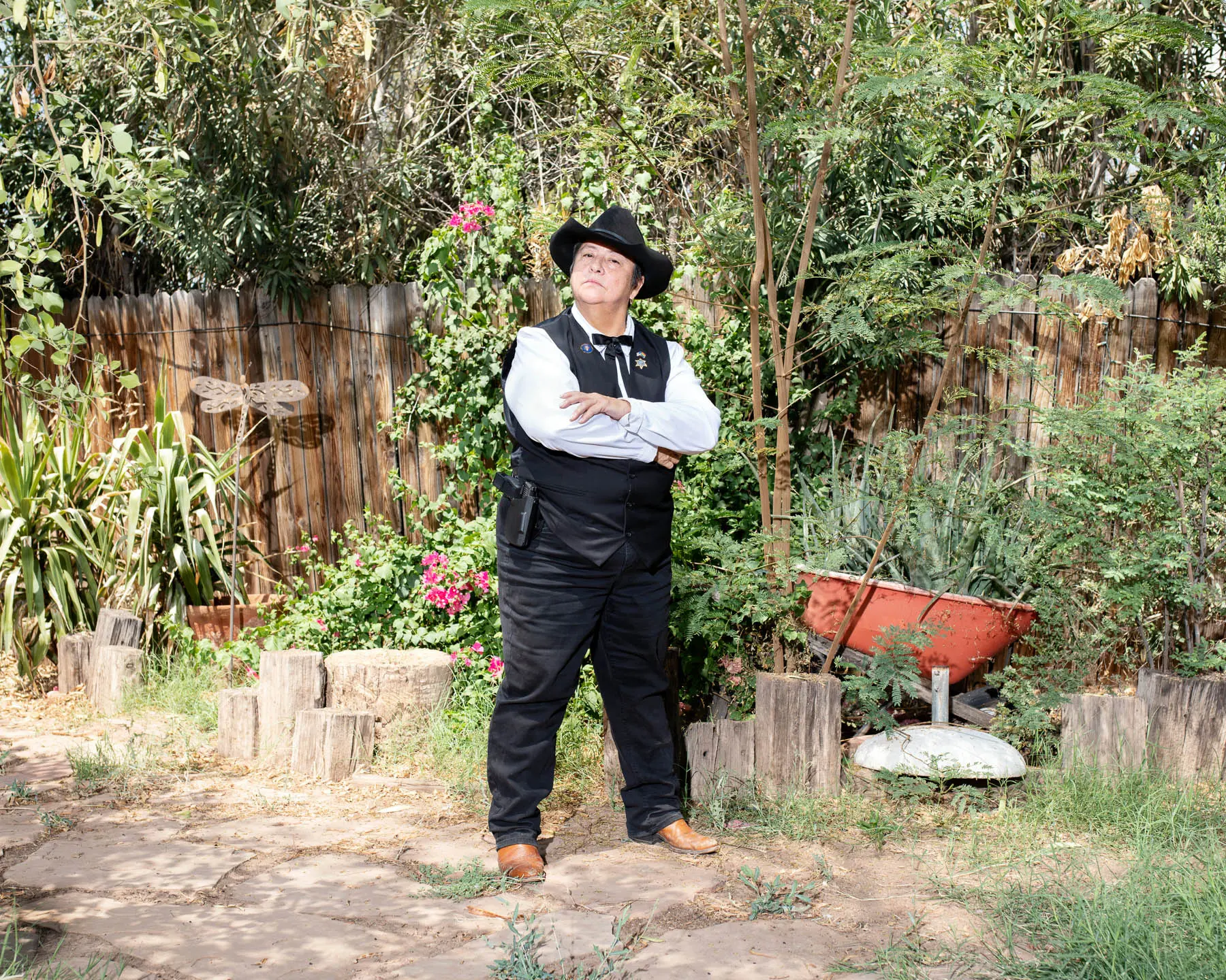 Woman stands in front of garden