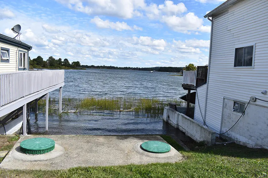 Image shows a septic system between two houses near a body of water in Rhode Island. 