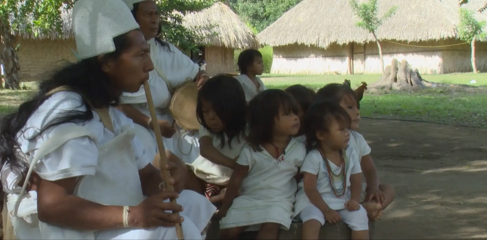 Family listening to their parent play an instrument 