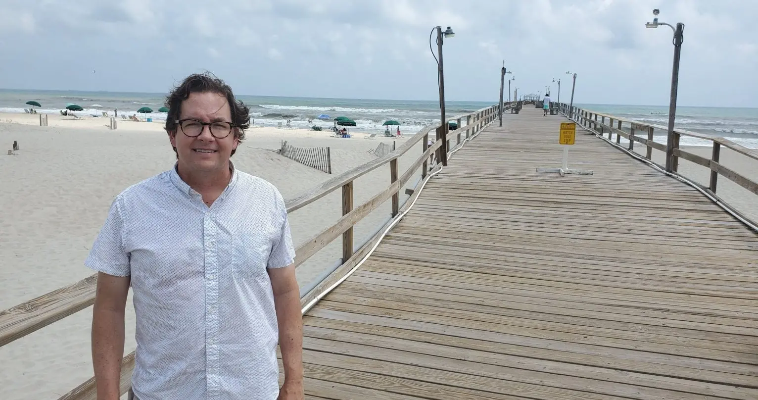 Mayor of Atlantic Beach poses in front of pier he owns