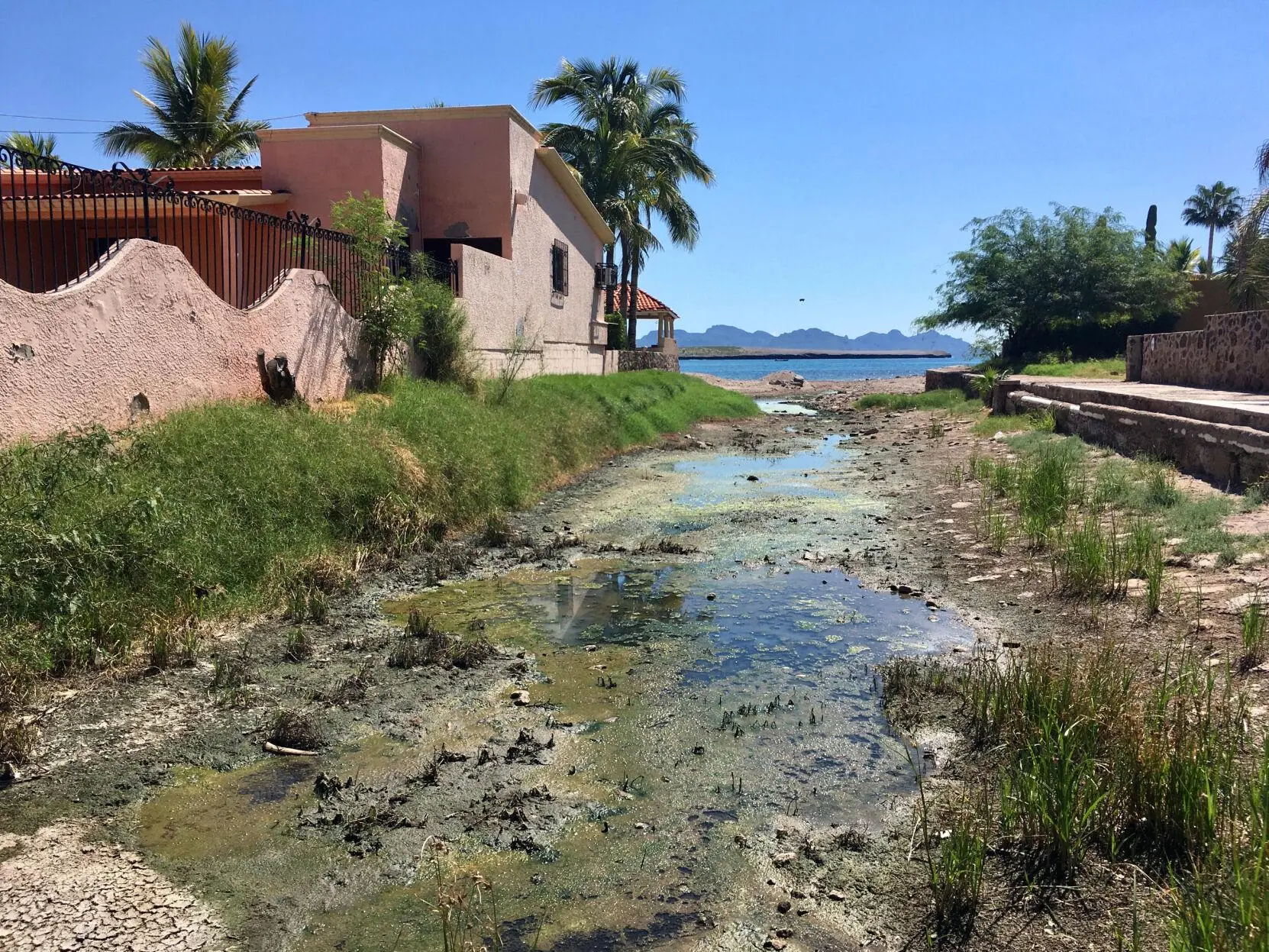 Sewage runs between homes in San Carlos