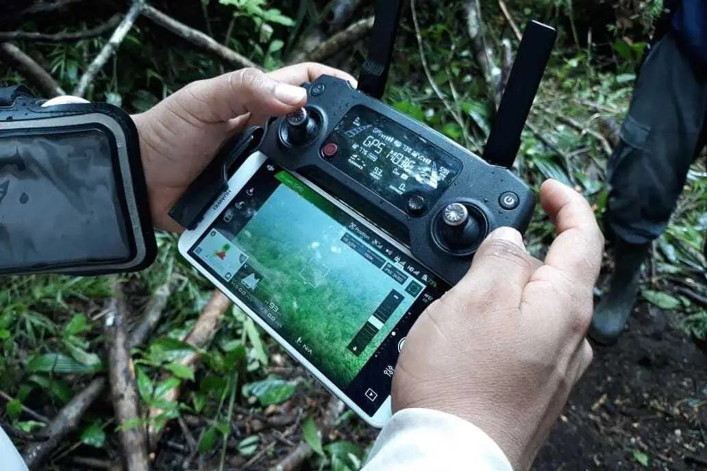 Hands hold a drone controller.