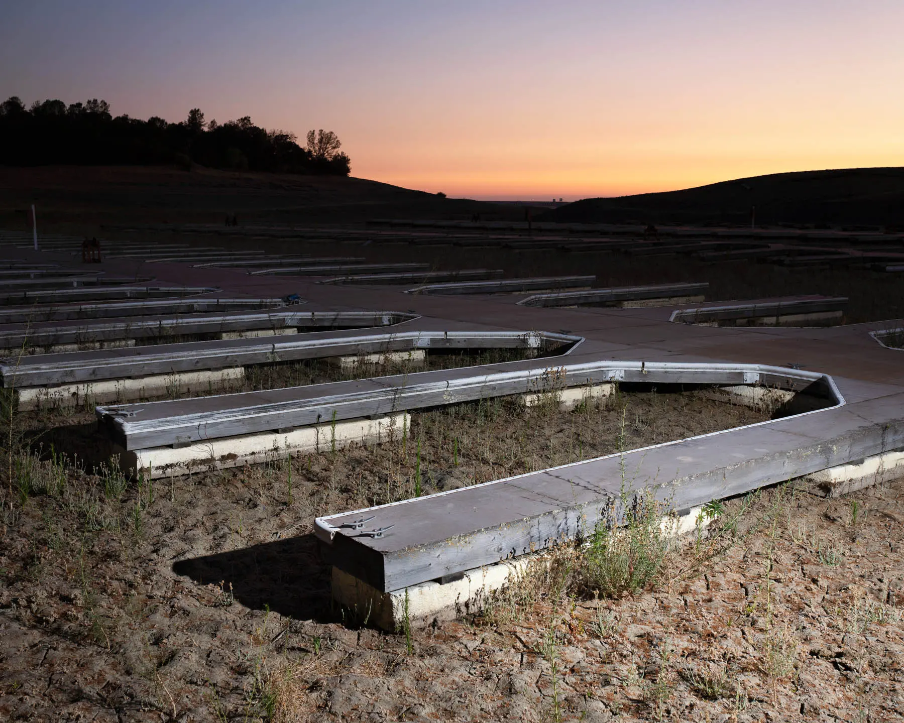 Boat docks in the drought sitting in empty reservoir