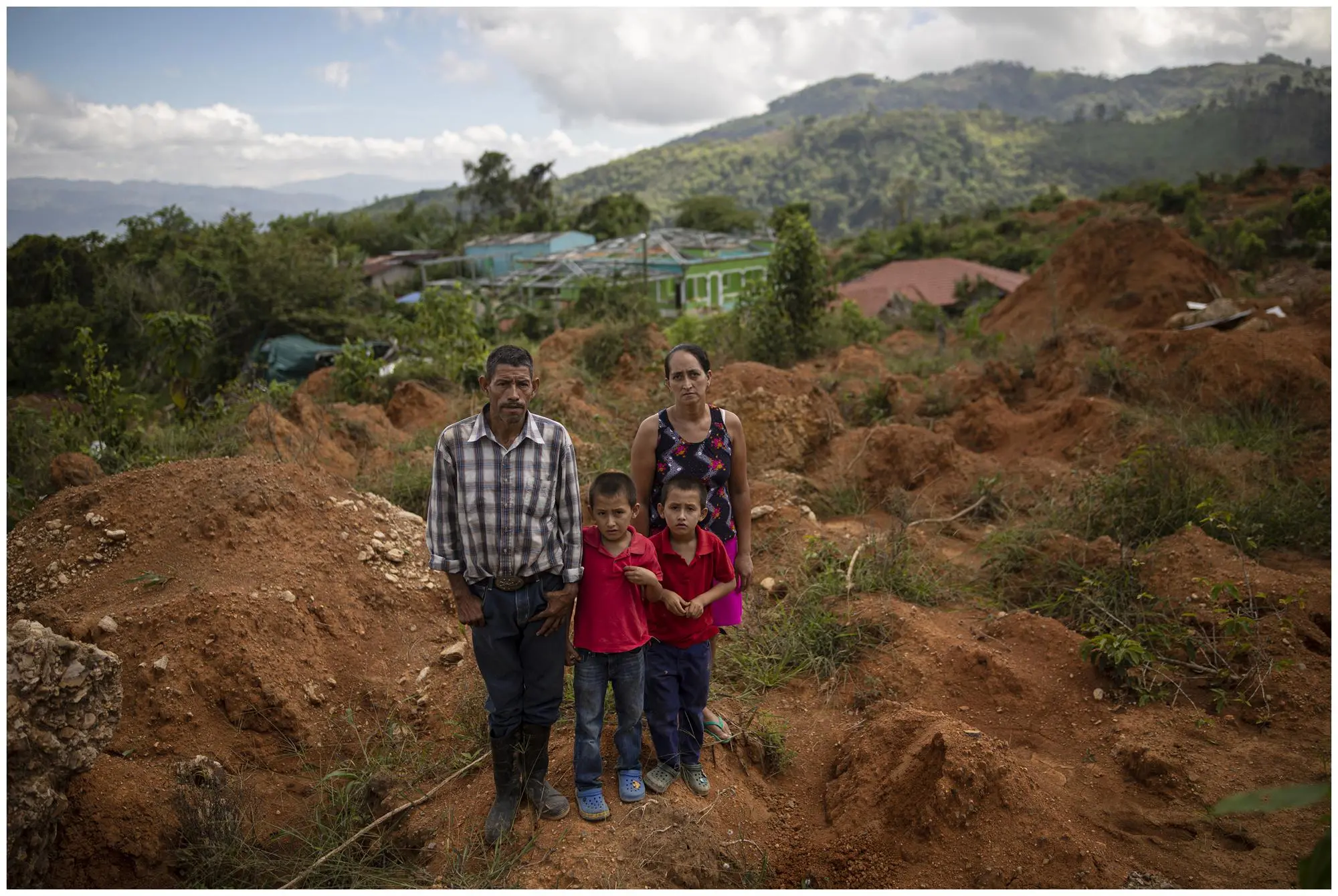 a family poses where there was home was destroyed