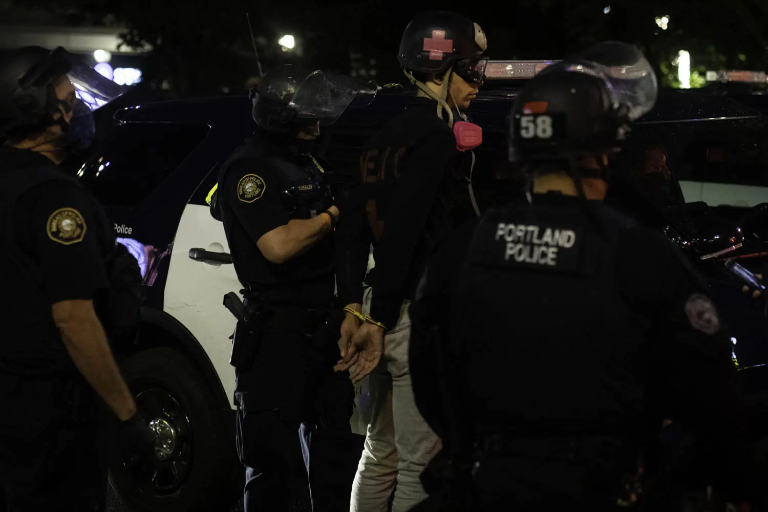 A medic is arrested during a protest on August 21, 2020, in Portland, Oregon.