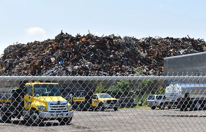 Photo of trucks in front of trash plant