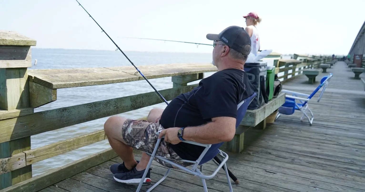 Men sit on fishing peer