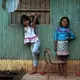 Angi and Sophia, Karina's nieces, pose against a wall of their home in Pucallpa.&nbsp;Image by Natalie Hutchison. Peru, 2017.