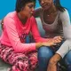 Yaneidi Nazaret, 17, cries besides her mother, who was charged 50 Bolivares to enter La Yaguara Detention Center, Caracas, to visit her daughter and bring her food. Image by Ana María Arévalo. Venezuela, 2018. 