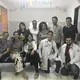 The multidisciplinary healthcare team at the USF&nbsp;in Córrego do Eucalipto. Each USF is supposed to be staffed with a physician, nurse, nurse assistant, and multiple community health agents, in addition to a primary care support team that may include nutritionists, psychologists, social workers, and others. Talita Rodrigues, 26, resident psychologist, is featured in the center in a patterned tank top, with Gerson da Silva, 25, the resident sanitarian, to her immediate right. Image by Poonam Daryani. Brazil, 2017.