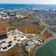 The Atlantic County Utilities Authority wastewater treatment plant in New Jersey can process 151 million liters of sewage from Atlantic City (in the background) and 13 nearby communities every day. Water came within 15 centimeters of flooding the facility during Hurricane Sandy in 2012. The utilities authority is building a US $3.7-million sea wall to protect the plant in the future. Image by Alex MacLean. United States, 2019.