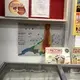A printed evacuation plan posted behind a freezer in a Huaraz grocery store. Image by&nbsp;Audrey Fromson. Peru, 2019.