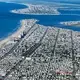 Looking south at Ventnor City on Absecon Island, just south of Atlantic City. “It’s a wonderful place to live,” says MacLean, “until a hurricane strikes or sea level starts to take hold.” The average elevation of the city is less than a meter above sea level, making it unusually vulnerable to sea level rise and storm surges. Minor flooding episodes in Ventnor City are eight times more common today than in the middle of the 20th century. Image by Alex MacLean. United States, 2019.