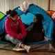 Gabriela, 22, left, and friend Daniela, 19, talk in a shelter in Tijuana. Gabriela, mother of two children, was shot several times in El Salvador. They talked about the risks women can face in their home country, including sexual assault, violence and death. The women fled and were in the process of applying for asylum. Image by Erika Schultz. Mexico, 2019.