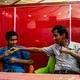 Hamza and Fathi wait for their food during lunch in Aden. Image by Alex Potter. Yemen, 2018.