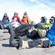 After five days of intense work, the team from the universities of Montana and Wyoming team packed up all the tents, food and gear, and waited for the helicopter to come pick them up. Image by Amy Martin. Greenland, 2018. 