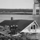 1938: Soldiers guarded a house that was blown into the Cape Cod canal under the Bourne Bridge during the hurricane. Image courtesy of Boston Public Library, Leslie Jones Collection. United States, 1938.