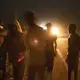 Ethiopian migrant Mohammed Eissa, second left, walks on a highway with boys he met on the way, about 50 kilometers (31 miles) from Djibouti, July 12, 2019. This was his third attempt to reach Saudi Arabia to find work; the previous trips ended in deportation. Eissa had left behind his wife, nine sons, and a daughter. His wife cares for his elderly father. His children work the farm growing vegetables, but harvests are unpredictable: 'If there's no rain, there's nothing.' Image by AP Photo/Nariman El-Mofty. Ethiopia, 2019.