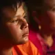 Daysi works ironing clothes at a laundry in Tijuana and her son, Jimmy, 12, sells shrimp at the beach near the U.S. border. Image by Erika Schultz. Mexico, 2019.