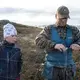 Ulf Isak Aleksandersen helps his father fix a fence. Image by Amy Martin. Norway, 2018.