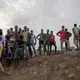 Ethiopian migrants stand on a hill at a slum in Dikhil, Djibouti, where they took shelter after entering the country, July 12, 2019, on their journey to Yemen. Most hope to eventually reach Saudi Arabia. Image by AP Photo / Nariman El-Mofty. Djibouti, 2019.