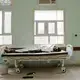 At the Ras al-Ara Hospital, Lahj, Yemen, Ethiopian migrant Dasto Mohammed lies on a gurney, July 26, 2019, after disembarking a boat and feeling sick from the journey. The flow of migrants to the beach is unending. On a single day, the AP witnessed seven boats arrive, each carrying more than 100 people. Mohammed came with her sister to Yemen to go to Saudi Arabia and seek work. Image by AP Photo / Nariman El-Mofty. Yemen, 2019.