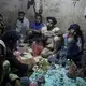 Ethiopian migrants chew qat, as they take shelter, Aug. 4, 2019, in a small shack at a qat market in Dhale province, one of the stops where migrants take shelter to continue their journey to Saudi Arabia, and an active frontline between Houthi rebels and militiamen backed by the Saudi-led coalition. Imageby AP Photo / Nariman El-Mofty. Yemen, 2019.