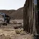 Mohammed Eisa, a 35-year-old Ethiopian farmer, and other migrants he met along the way, take shelter inside a damaged shipping container on the side of a highway, near Lac Assal Djibouti, July 14, 2019. Many migrants have made the journey to Saudia Arabia multiples in what has become an unending loop of arrivals and deportations. Eissa is among them; this is his third trip to Saudi Arabia. Image by AP Photo / Nariman El-Mofty. Djibouti, 2019.