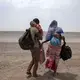 Fatma and her husband Yacoub, migrants from Mali, carry their children as they make their way in Lahj, Yemen, July 23, 2019. Image by AP Photo / Nariman El-Mofty. Yemen, 2019.