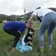 Working as a pair, Beckles and Negrón prepare to carry the dog to Beckles’ car. Image by Jamie Holt. United States, 2019.