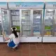 A worker takes care of inventory at a TH Truemart factory store in Nghia Son, Vietnam. Image by Mark Hoffman. Vietnam, 2019. 