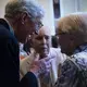 Pulitzer Center board member Richard Moore speaks with guests Lincoln Day and Alice Day. Image by Lorraine Ustaris. Washington, D.C., 2018.