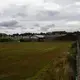 A polluted and fenced-off soccer field owned by Glasgow City Council. The soccer field, which was polluted by an iron industry that left town in the late 1960s, is located behind the Possilpoint Community Centre and will be the future location of a new community facility. Image by Michael Santiago. United Kingdom, 2019.